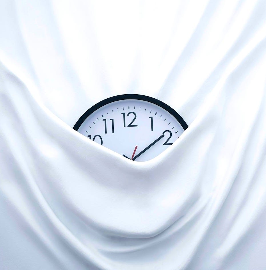 round black clock on linen