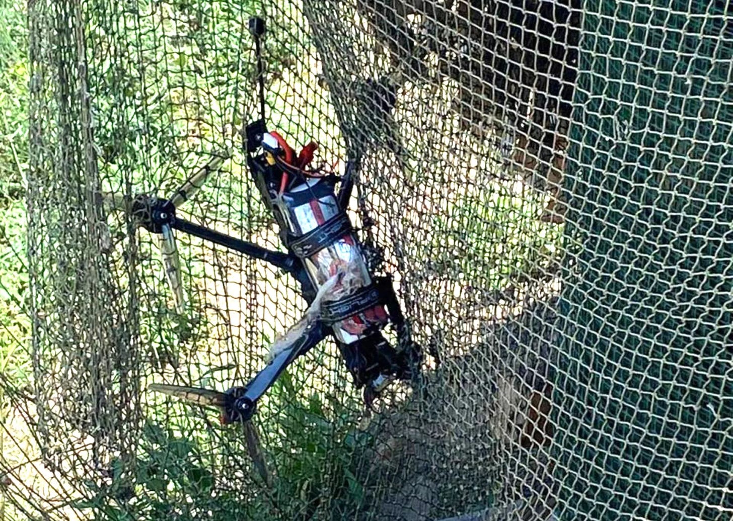 An FPV drone caught in a net. An FPV drone caught in a net.
