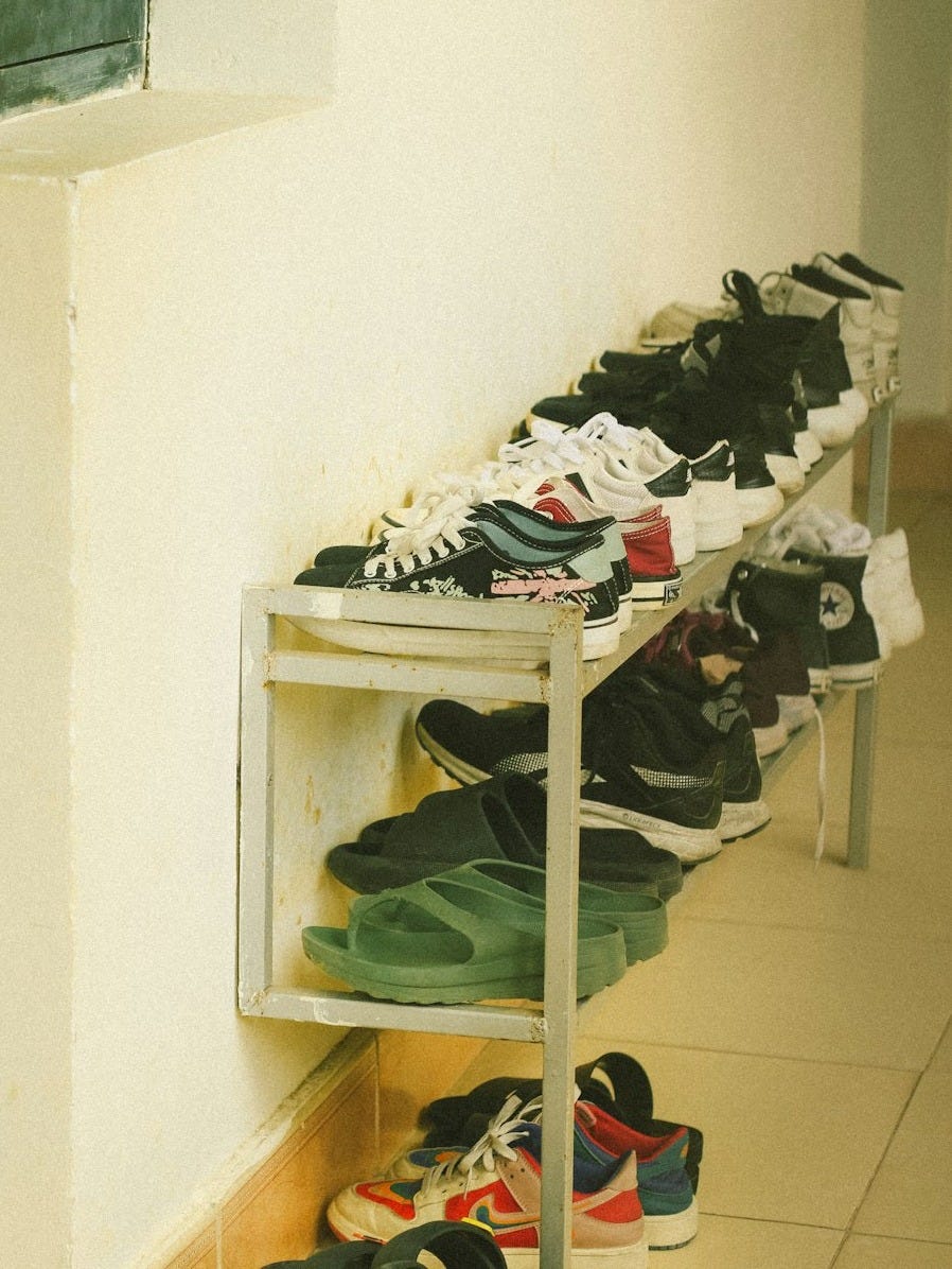 a bunch of shoes that are on a shelf