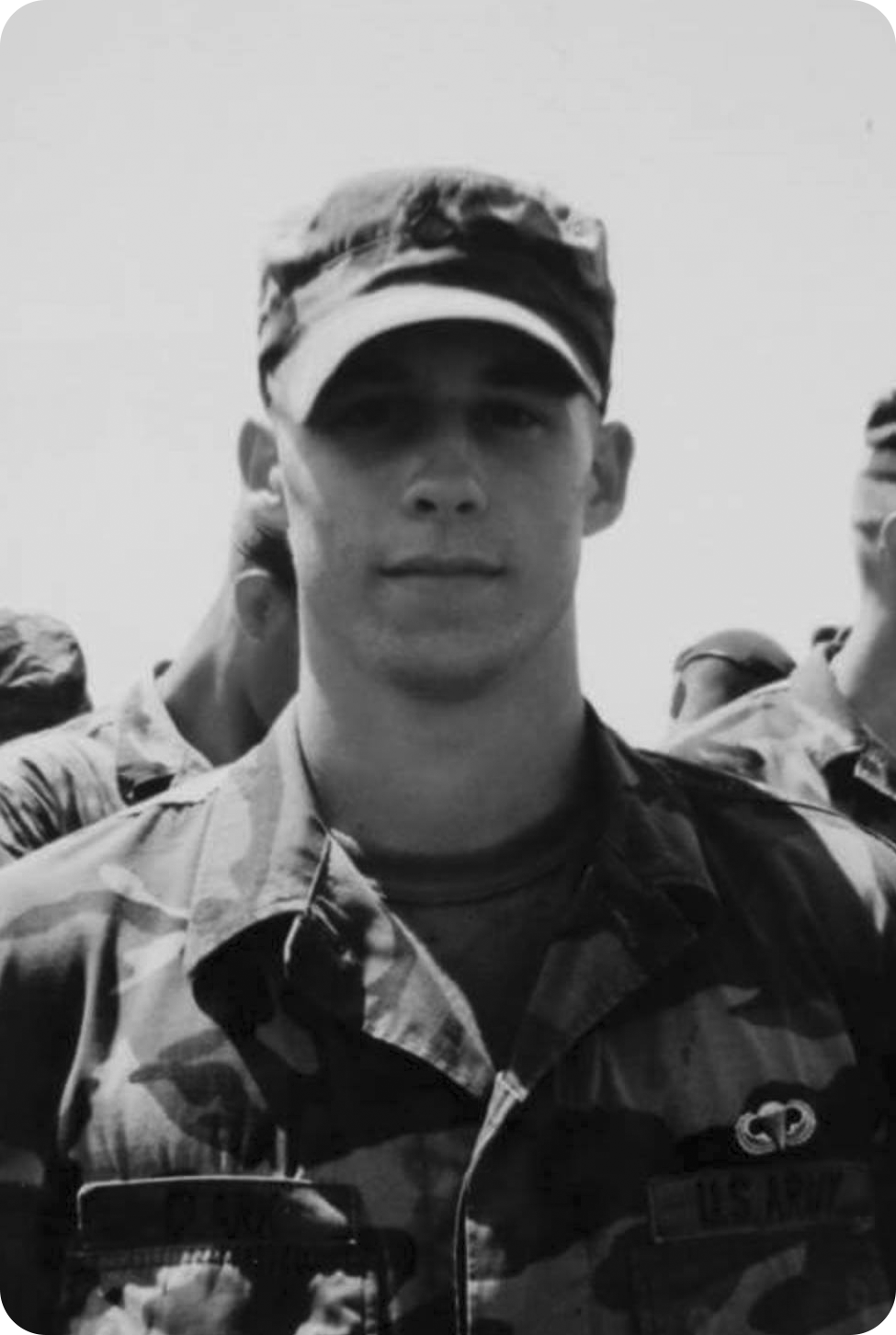 Black and white photo of John in his military uniform with jump wings