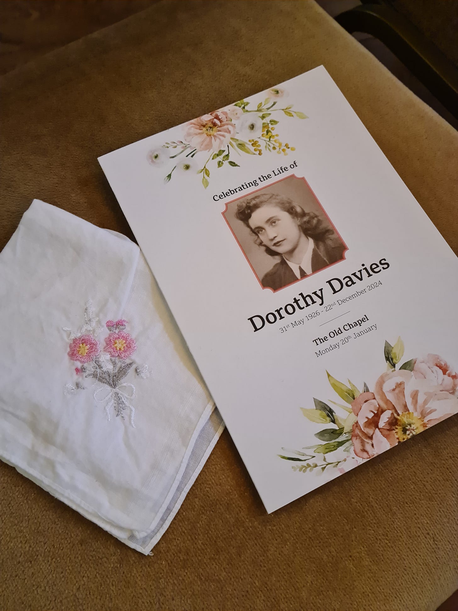 The Order of Service at our nan's funeral with one of her many embroidered handkerchiefs