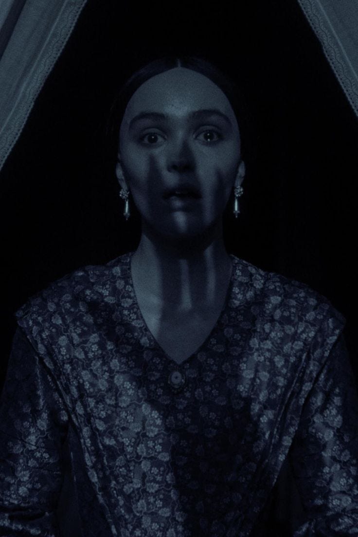 This may contain: a woman is standing in the dark with her eyes open