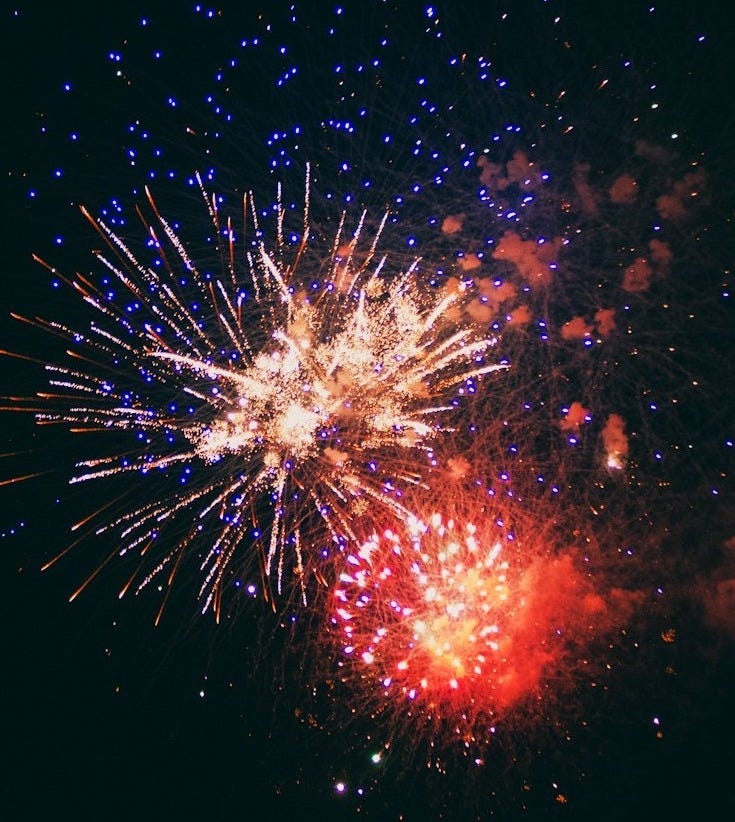a colorful fireworks display in the night sky