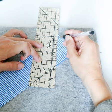 marking the cutting line for a triangular tip on fabric marking the cutting line for a triangular tip on fabric