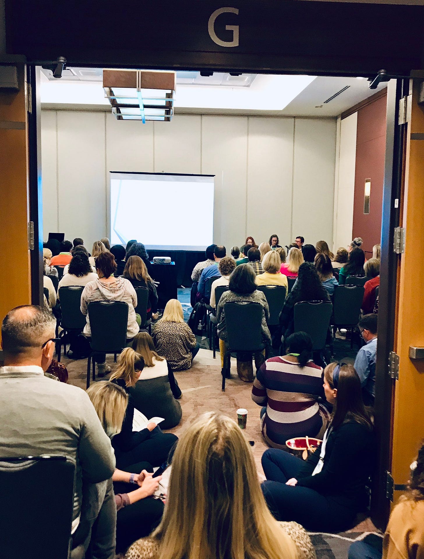 Image description: Our panel session at NAGC 2022 was packed and the audience spilled out into the hallway. Image description: Our panel session at NAGC 2022 was packed and the audience spilled out into the hallway.