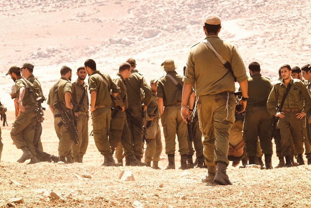 Israeli soldiers during military training between the villages of Al-Mirkez and Jinba in Masafer Yatta, June 22, 2022. (Ali Awad) Israeli soldiers during military training between the villages of Al-Mirkez and Jinba in Masafer Yatta, June 22, 2022. (Ali Awad)