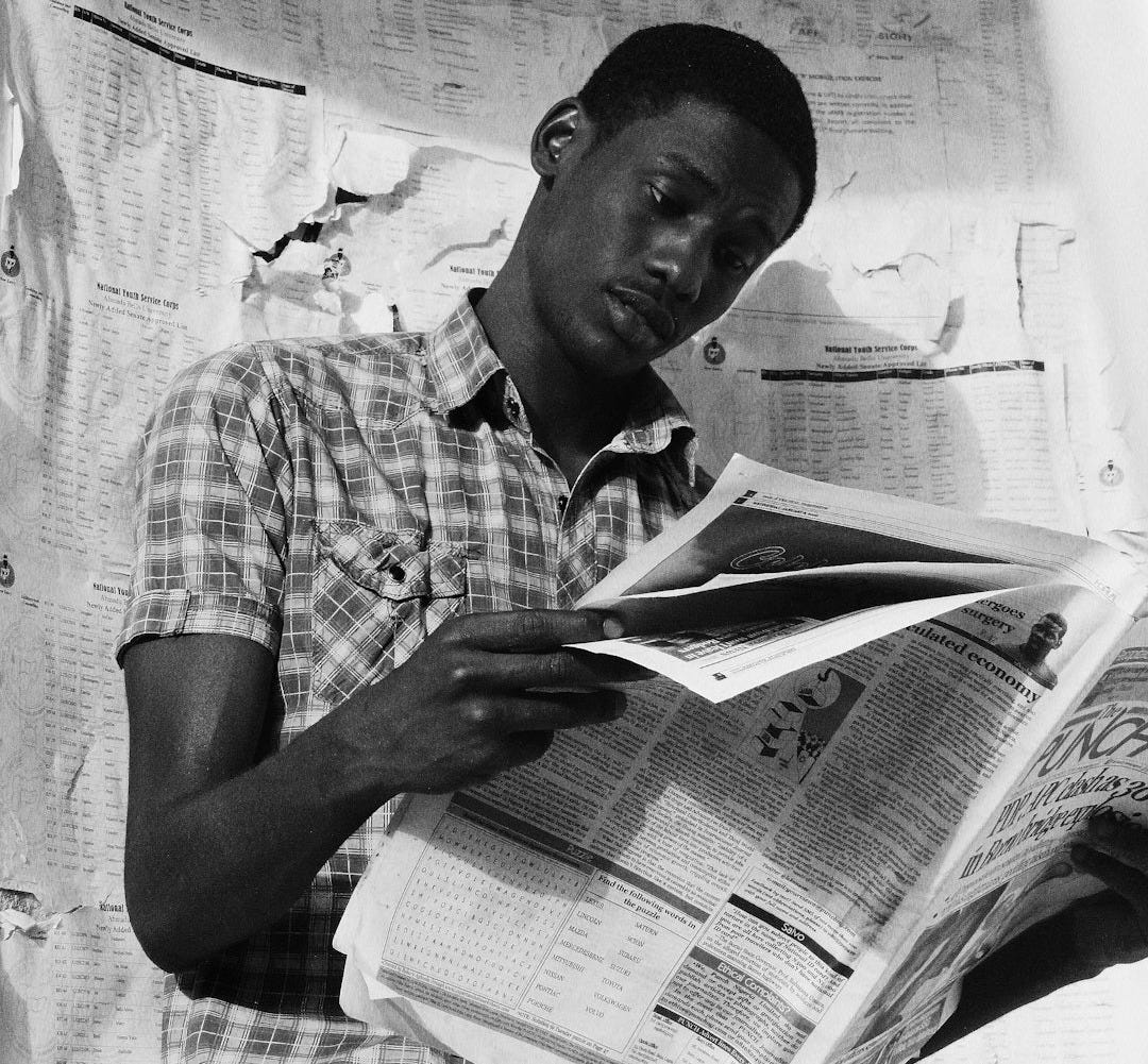 man in plaid shirt reading book