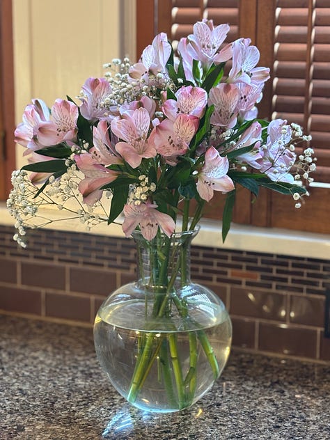 A vase or yellow, pink and red roses.. A vase of pink. A vase of assorted white flowers.