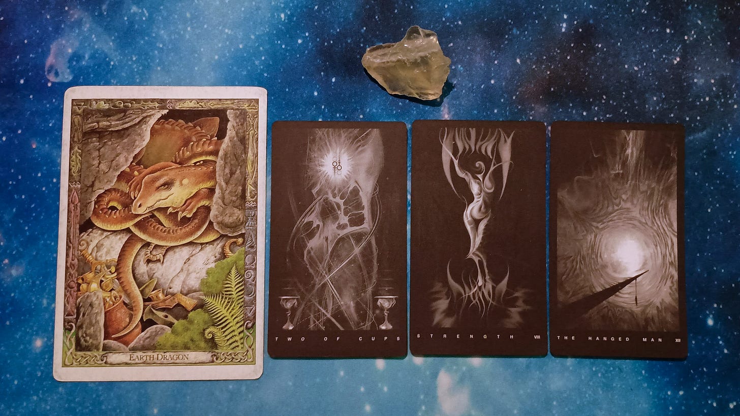 New Moon Magic: Your July 2025 Pick-a-Card Tarot Reading, pile 4 - citrine (yellow) stone and 4 cards on a starry blue background