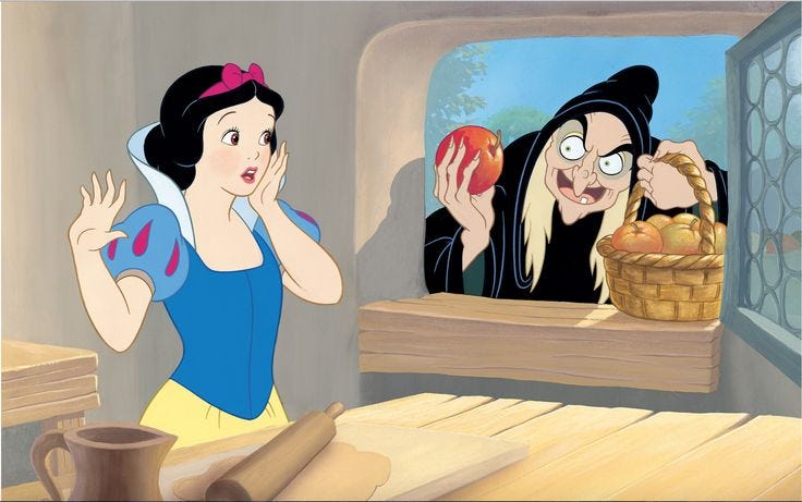 Disney's Evil Queen offering Snow White the poisoned red apple Disney's Evil Queen offering Snow White the poisoned red apple