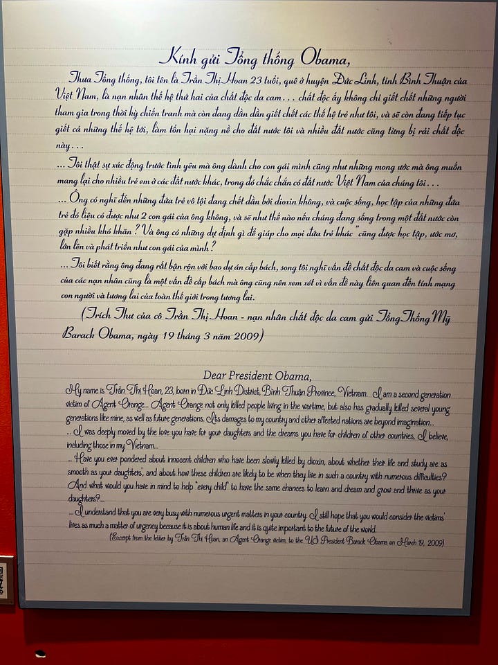 Left: Color photograph showing a young Vietnamese woman in a wheelchair in a library, teaching several children who stand beside her holding books. Bookshelves line the walls behind them. The museum caption identifies her as Huỳnh Thanh Thảo, born in 1986, an Agent Orange victim who became a teacher despite being unable to walk. Right: Museum display showing a letter written in Vietnamese and English to President Barack Obama from Trần Thị Hoan, an Agent Orange victim born in 1986. The letter, dated March 19, 2009, describes her disability and asks Obama to consider the lives of children affected by Agent Orange, noting that the chemical continues killing people long after the war.