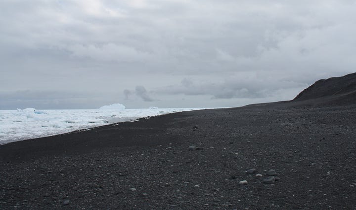 Two images showing beaches of dark stones, sea with ice and a grey sky, as described in opening paragraph