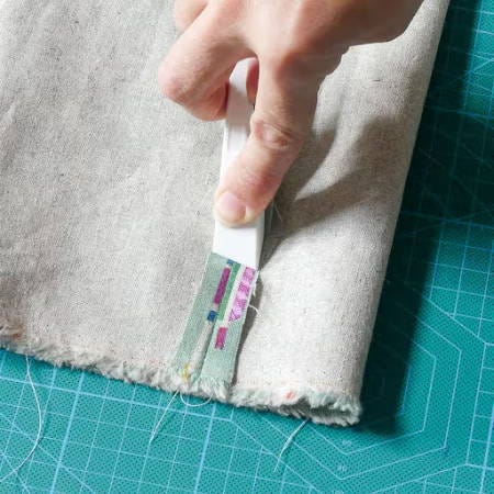 using a finger presser tool on a seam