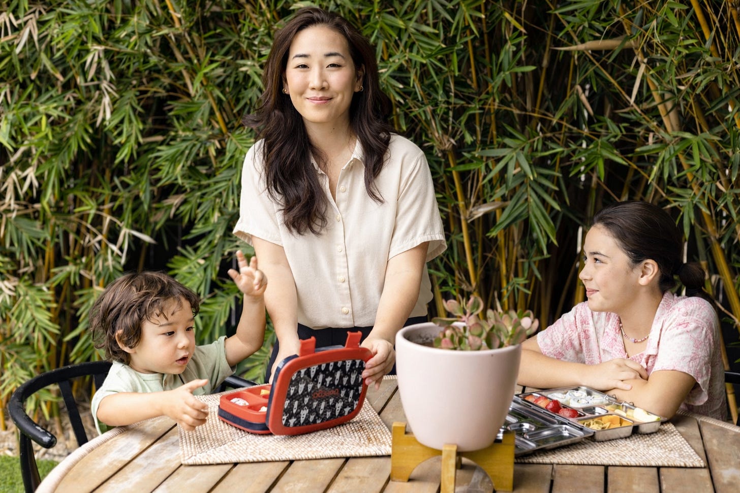 Jane Nicholson outside with her son and daughter eating snacks Jane Nicholson outside with her son and daughter eating snacks