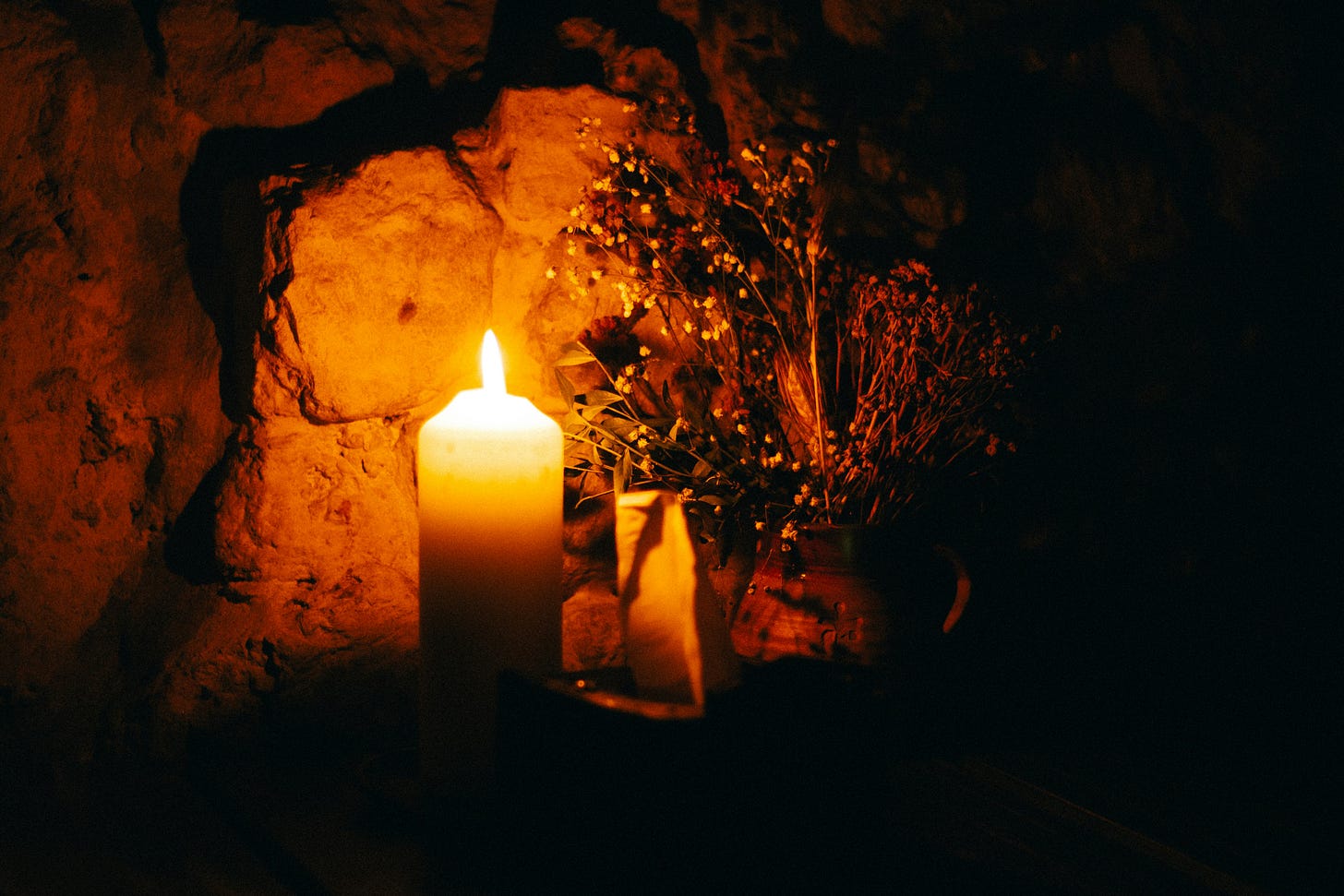a candle with some dried flowers a candle with some dried flowers