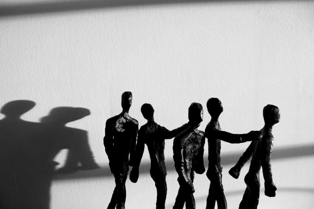 a shadow of a group of people holding hands a shadow of a group of people holding hands