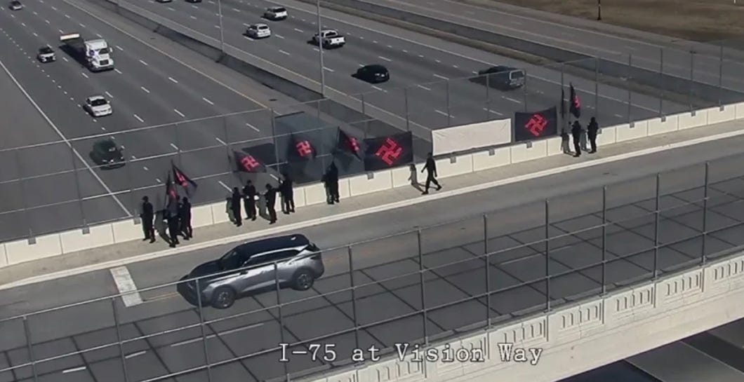 A group of people walking on a highway

AI-generated content may be incorrect.