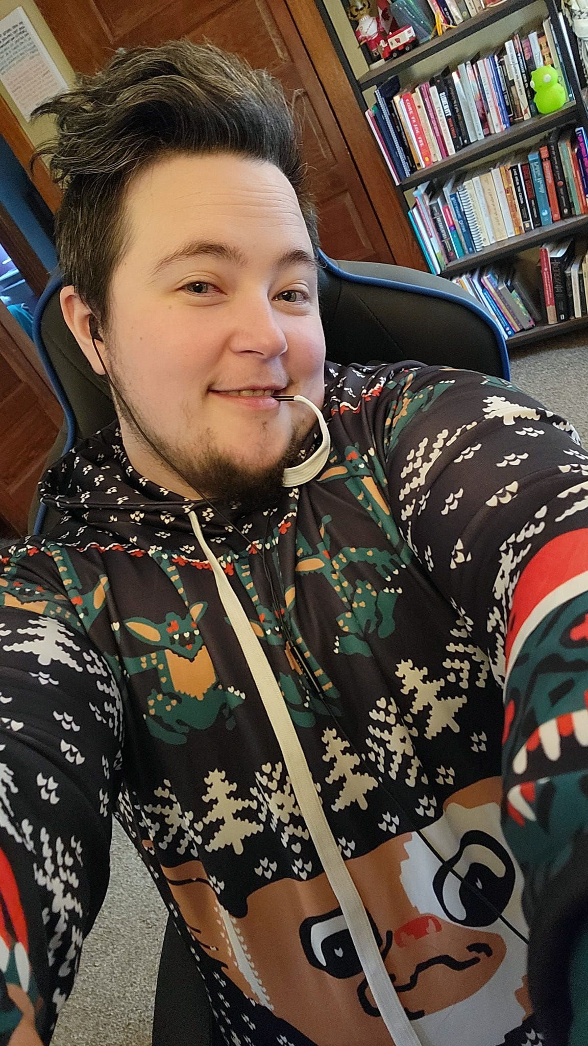 Grayson wearing an "ugly" holiday sweatshirt that is Gremlins themed