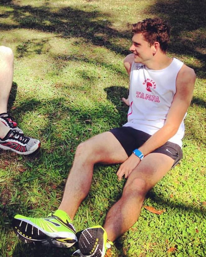 Sitting on the grass after the New Orleans marathon, wearing a Tampa singlet, appearing calm but still battling disordered habits underneath. Sitting on the grass after the New Orleans marathon, wearing a Tampa singlet, appearing calm but still battling disordered habits underneath.