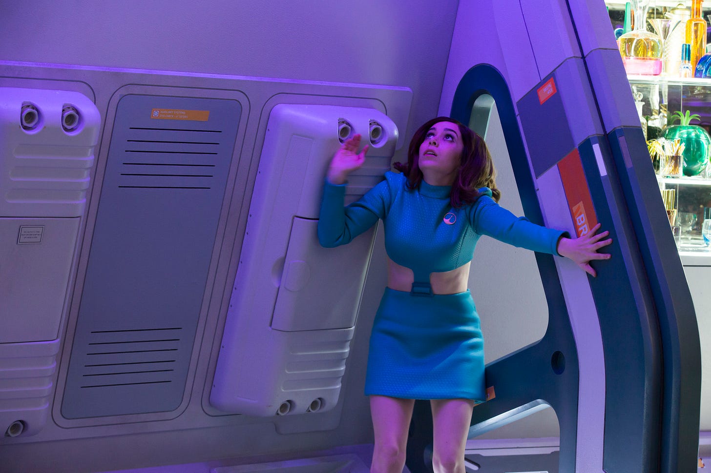 a blue mini-skirted star trek looking woman looks nervously up in a ship hallway a blue mini-skirted star trek looking woman looks nervously up in a ship hallway