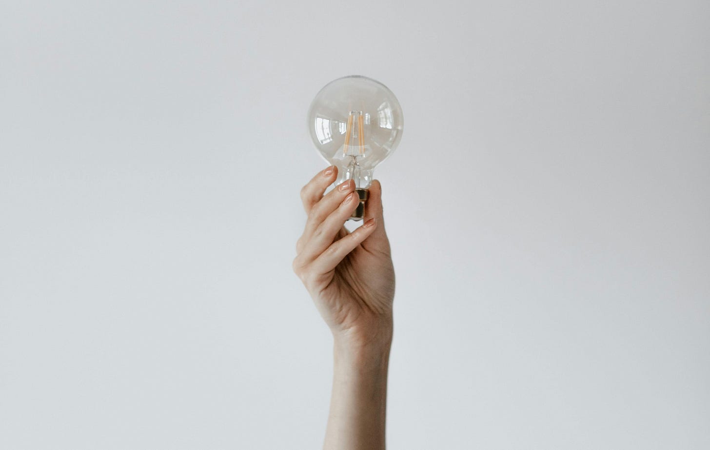 Hand holding a lightbulb