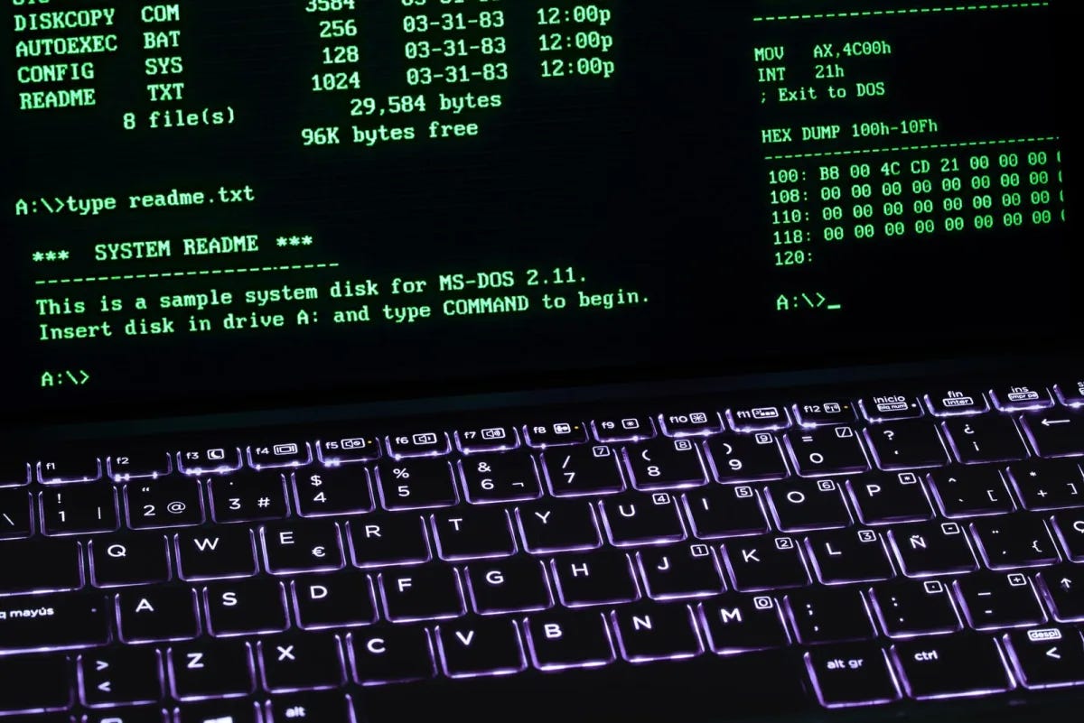 A retro green-on-black terminal screen next to a backlit keyboard