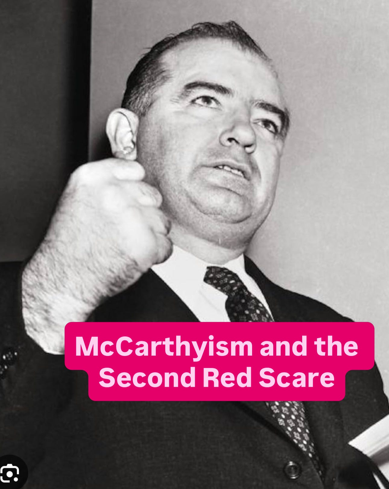 A person in a suit and tie

AI-generated content may be incorrect.