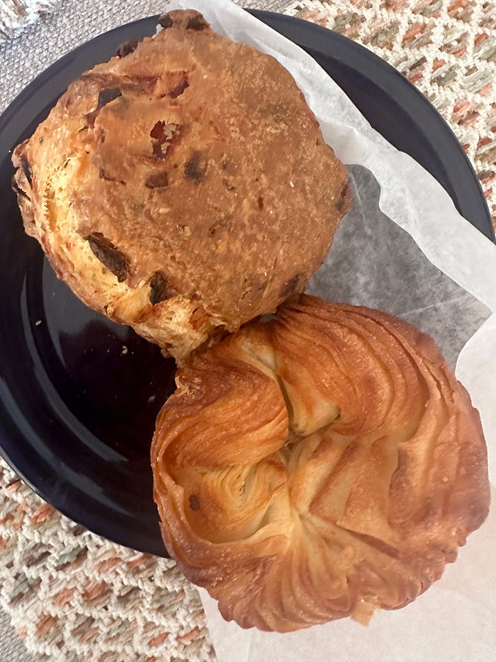 Two photos: one of pita crackers, vegetable soup, and oranges from Trader Joe's, and one of a biscuit and kouign-amann from a local bakery.