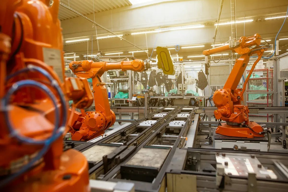 robot arms on an automated assembly line robot arms on an automated assembly line
