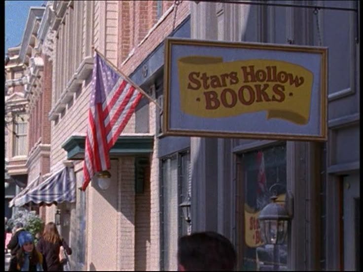 This may contain: people walking down the street in front of stars hollow books