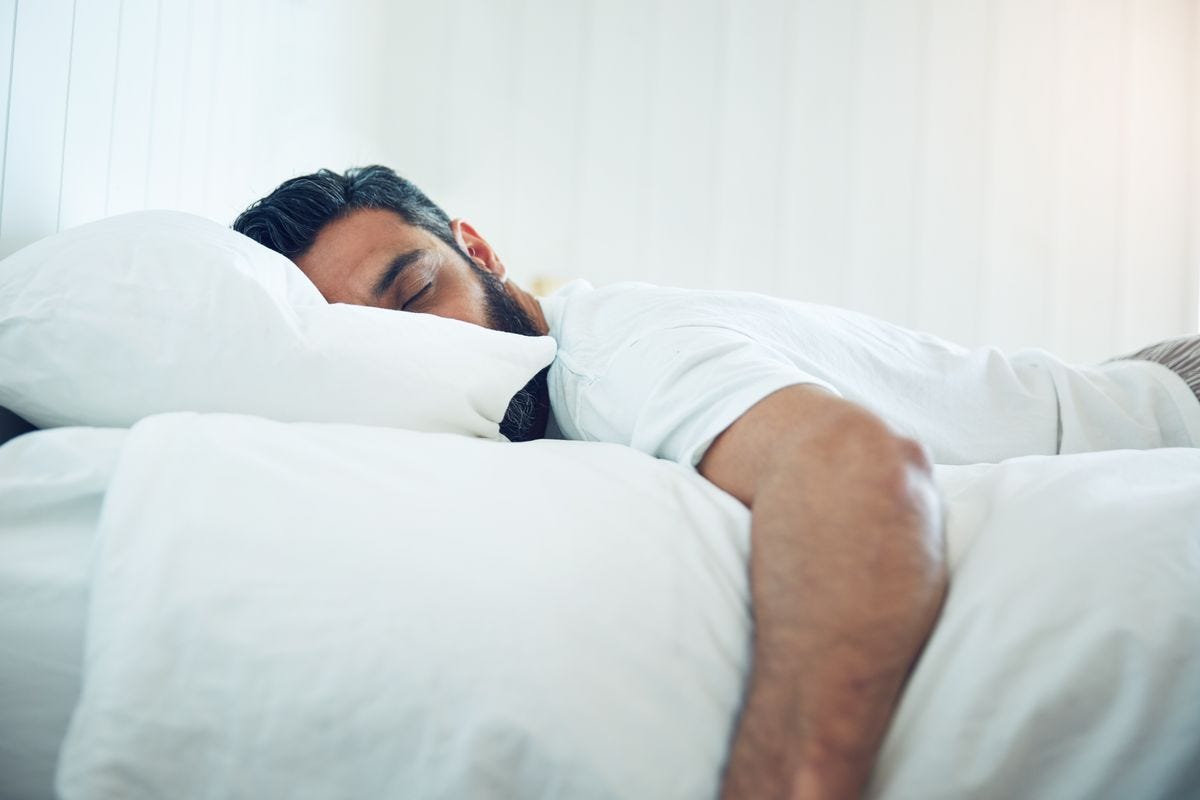 Man sleeping face-down in a bed. Man sleeping face-down in a bed.