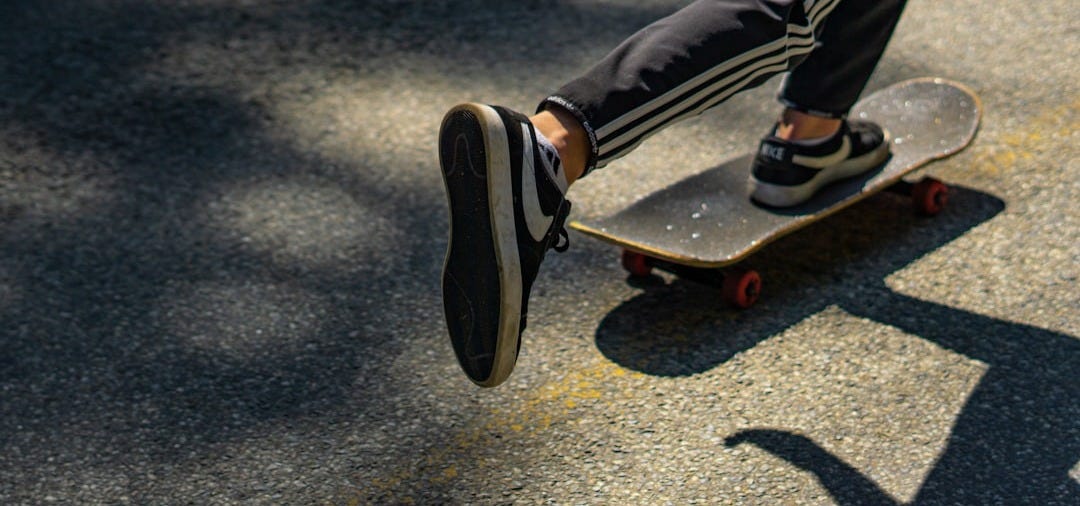 person in black and red sneakers riding skateboard person in black and red sneakers riding skateboard