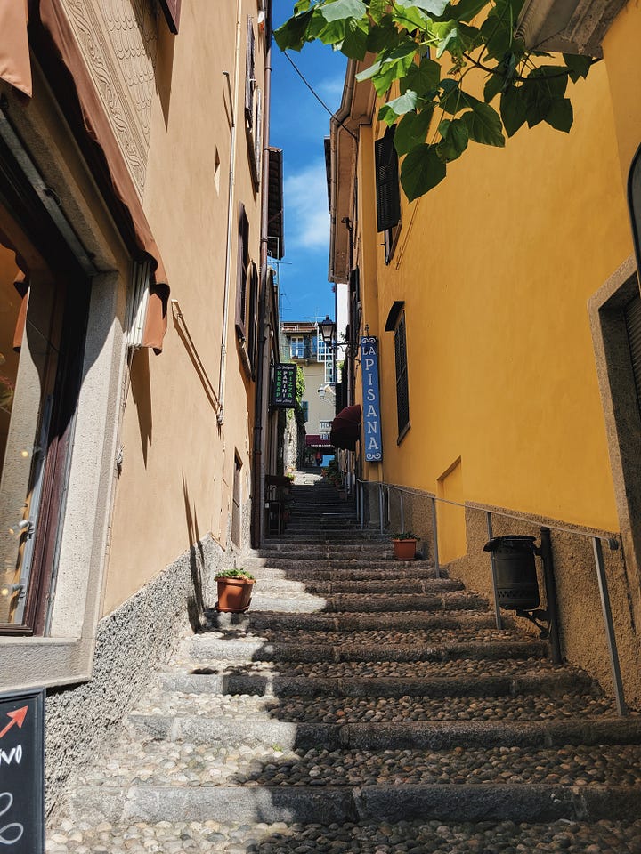 Shops along Salita Serbelloni and a narrow hillside street in Bellagio