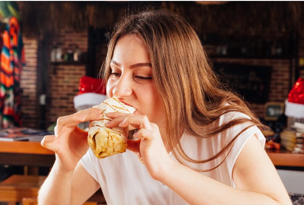 woman eating a burrito