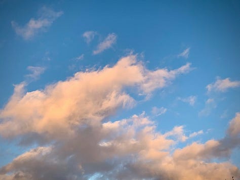 Image one is of golden clouds in a blue sky, image two is of a stream at sunset, image three is a poster on a telephone pole.