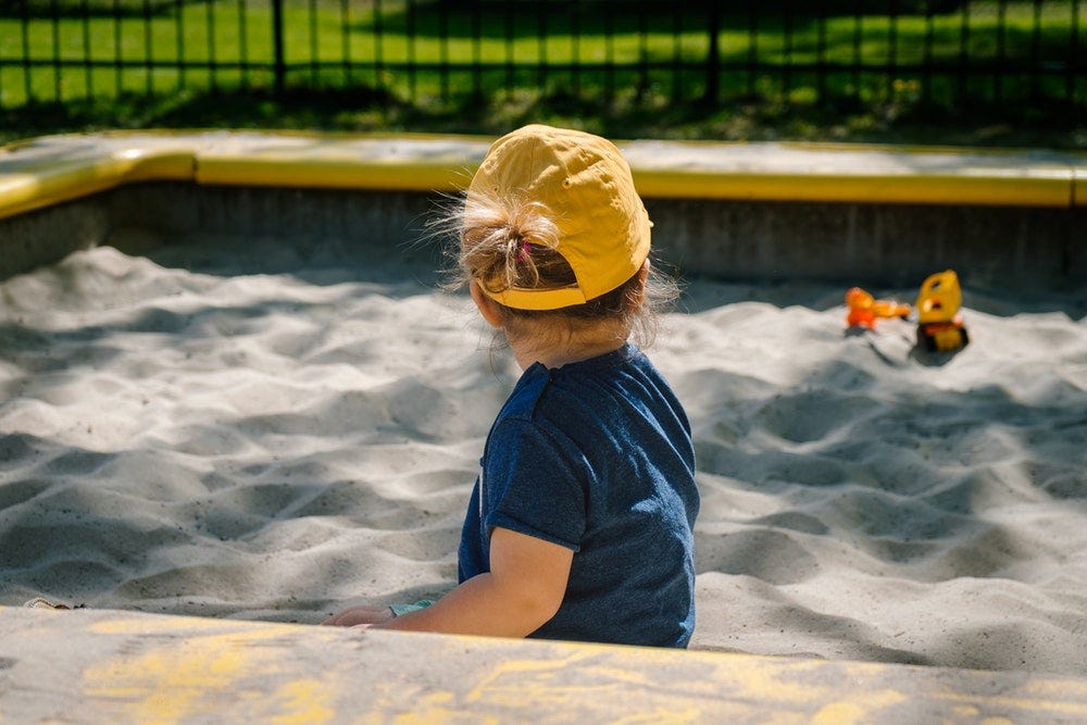 girl playing on sand box girl playing on sand box