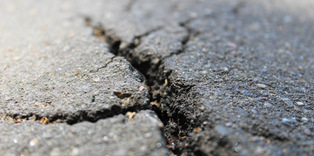 a crack in the asphalt of a road