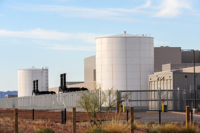 Meta data-center campus with large water tanks and secure fencing.
