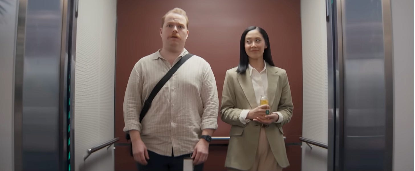 Scene from Beat IT Misery campaign video with two IT professionals in an elevator experiencing two entirely different situations.