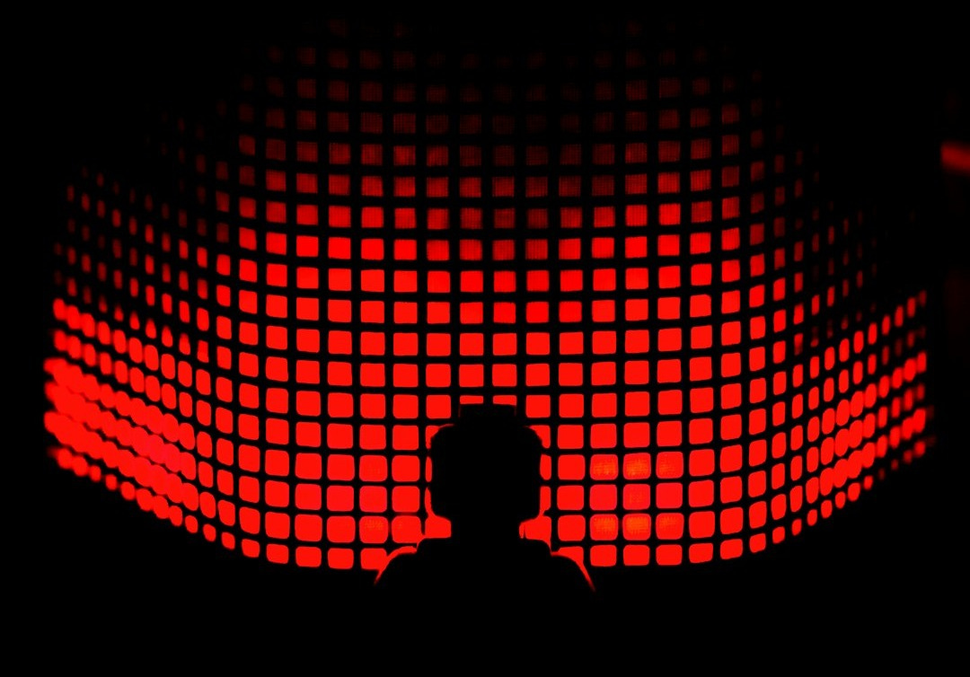 a person standing in front of a red light