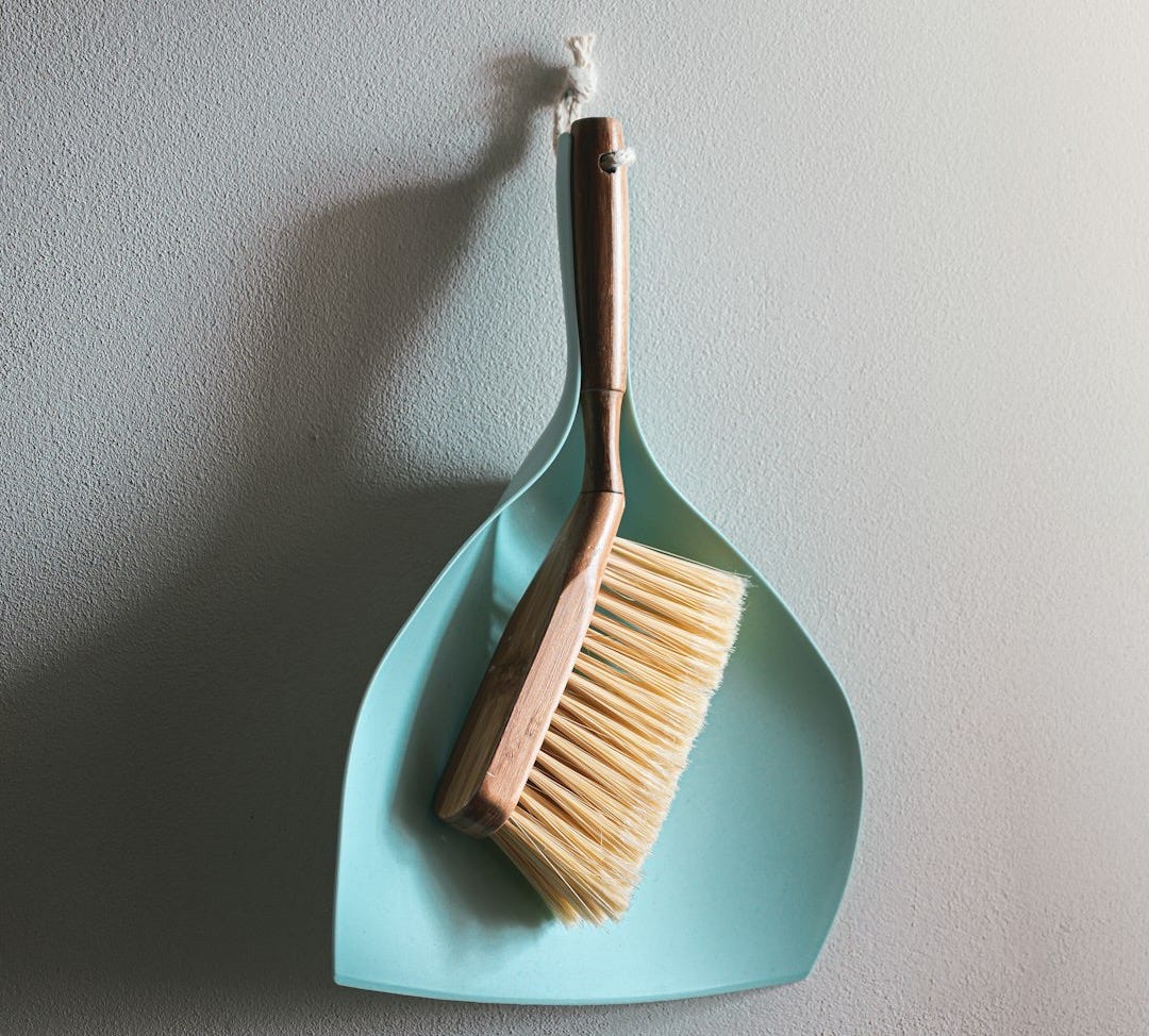 brown wooden brush on white wall