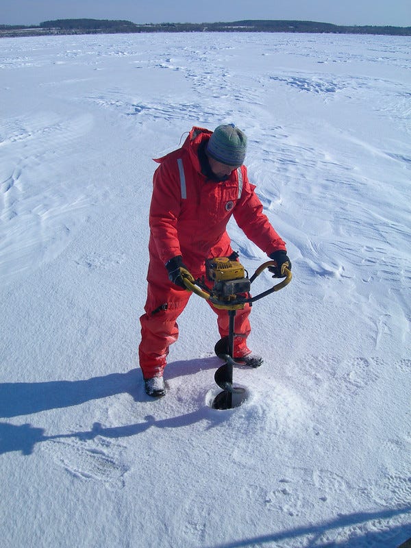 A worker drilling a hole to use for sampling the ice in Lake Michigan. A worker drilling a hole to use for sampling the ice in Lake Michigan.