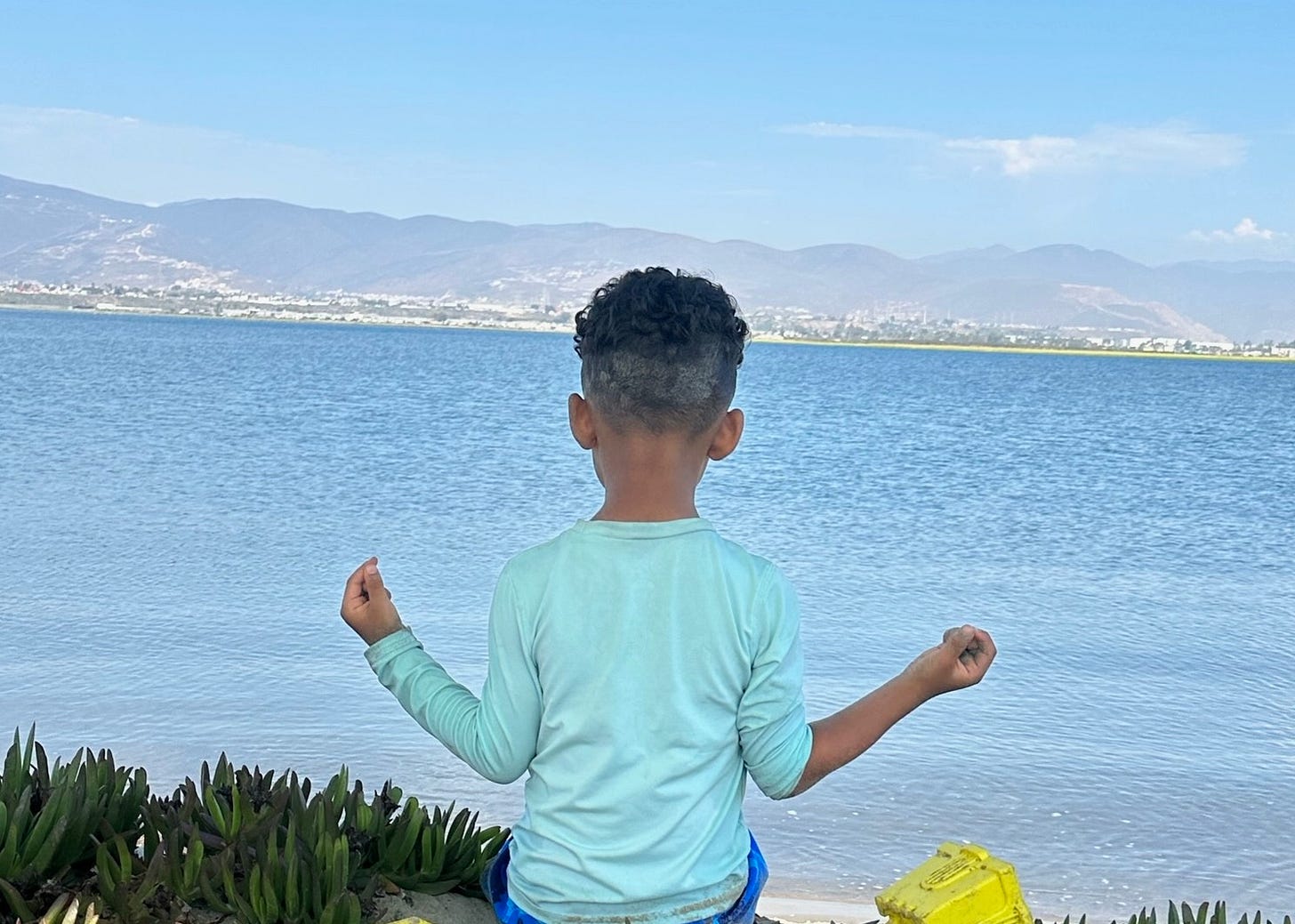 little boy meditating with a view