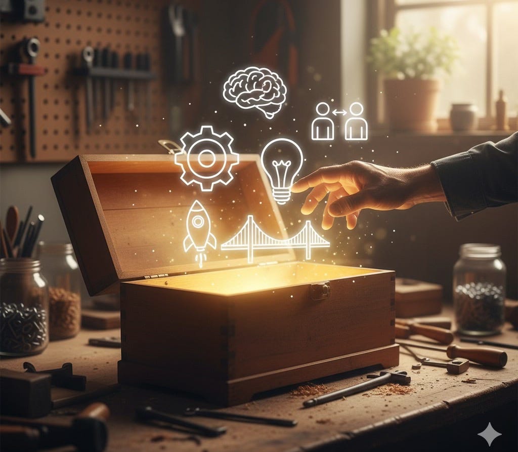 A wooden toolbox sits open on a workbench, glowing with bright light. Above it, abstract white line icons representing skills like a gear, a brain, a lightbulb, a rocket, and a bridge float upwards. A hand reaches in to touch one of the glowing icons. The background shows a blurry workshop with tools and a window. A wooden toolbox sits open on a workbench, glowing with bright light. Above it, abstract white line icons representing skills like a gear, a brain, a lightbulb, a rocket, and a bridge float upwards. A hand reaches in to touch one of the glowing icons. The background shows a blurry workshop with tools and a window.