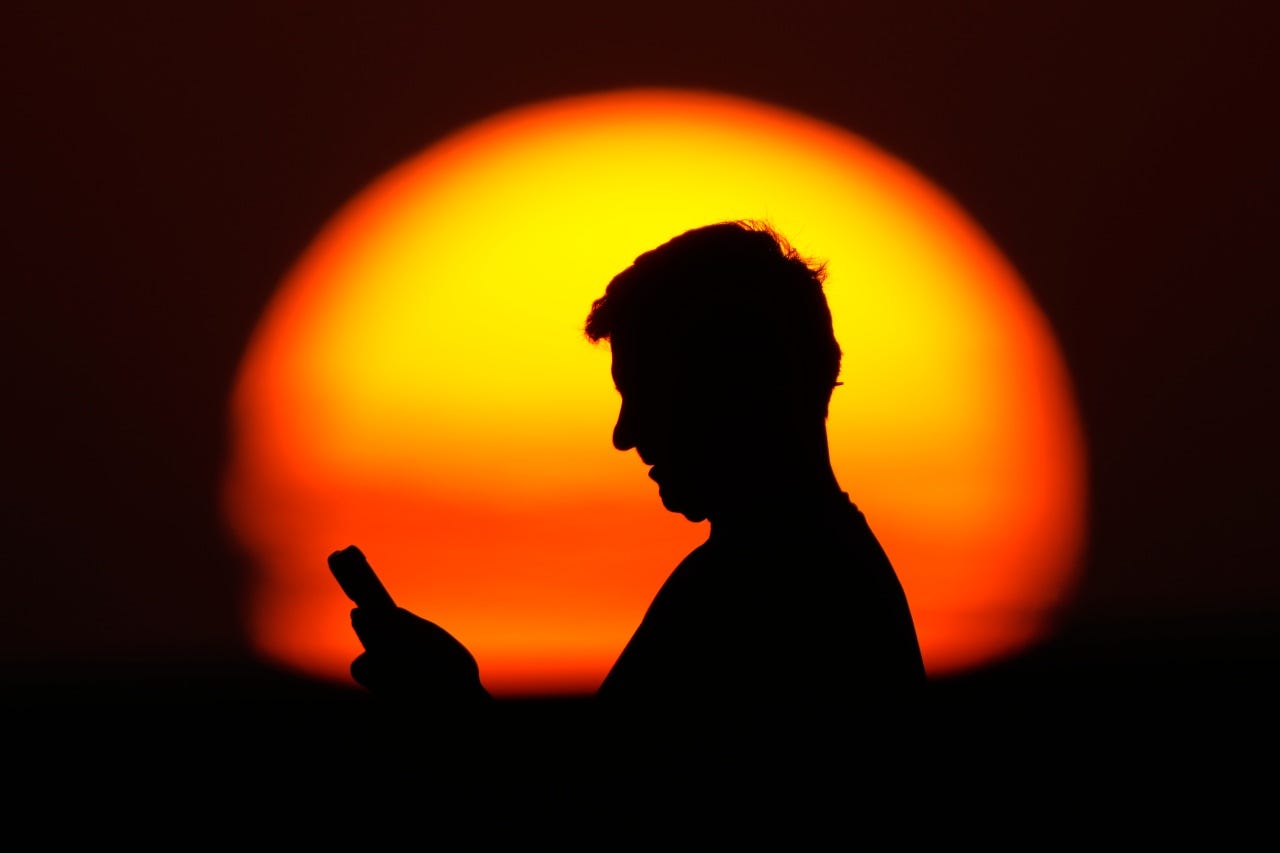 A man looks at his phone in Kansas City, Mo, July 26. A man looks at his phone in Kansas City, Mo, July 26.