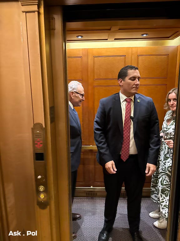 A politician looks at his aide who's staring at the photographer. Photo: Matt Laslo © www.askapol.com 