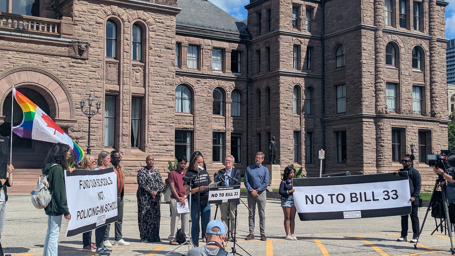 Photo of speakers in front of Queen's Park campaigning against Bill 33.