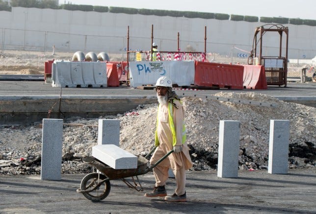 A construction worker in Qatar. Builders work on a construction site in Doha, Qatar, 10 March 2015. Qatar is to host the 2022 soccer world. Qatar drew international criticism concerning the vote to host the world cup and regarding the working conditions of foreign construction workers and buiders.  Photo by: Bernd von Jutrczenka/picture-alliance/dpa/AP Images