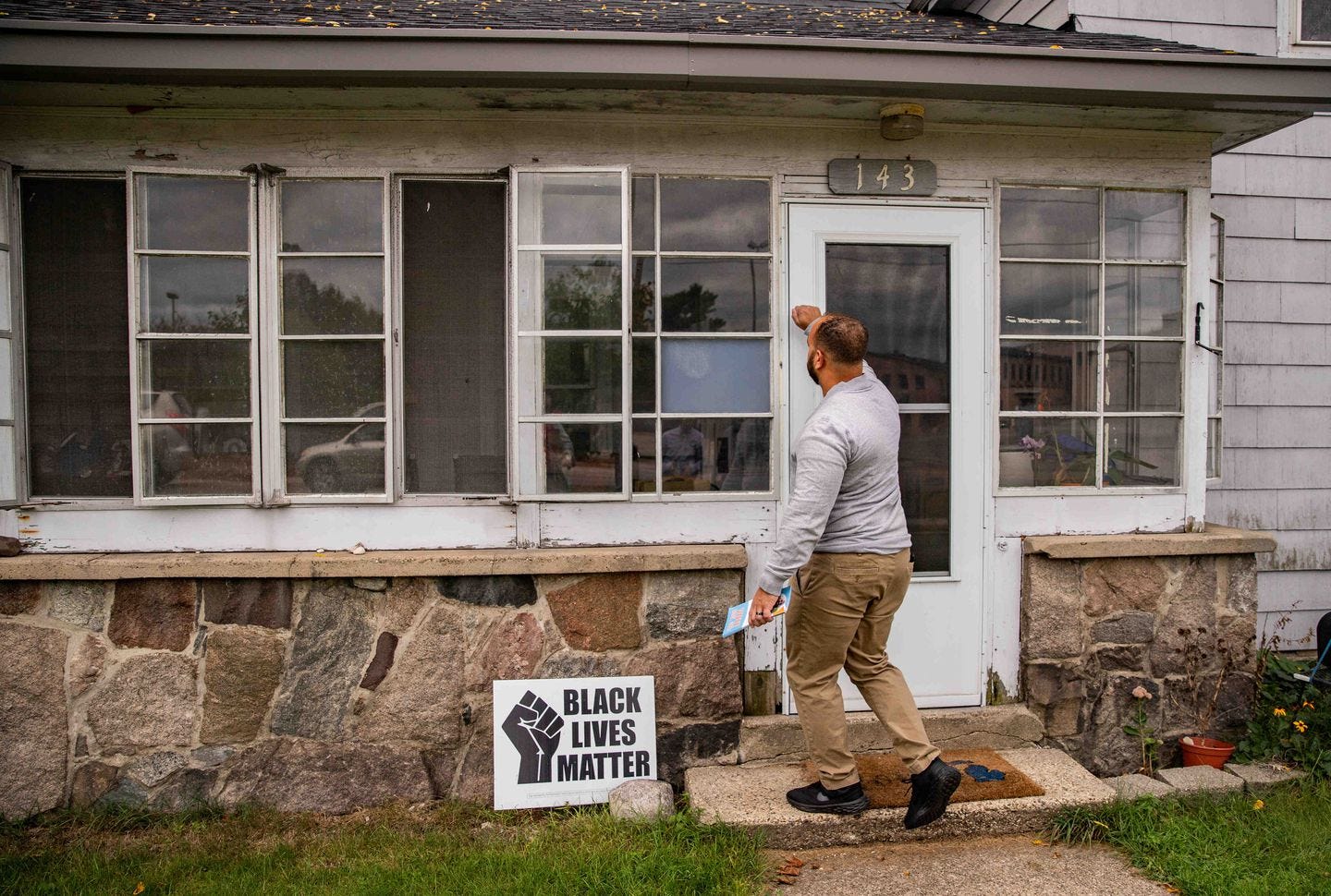 A Democratic nominee for Congress, Joseph Alfonso, knocks on doors around downtown Plainwell, Mich.