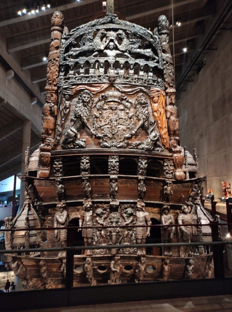 Carvings of people and Sweden's coat of arms on the back of the ship